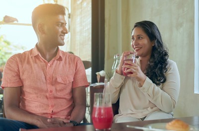 The Baby Decision expert coaches - young Indian couple drinking smoothies